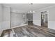 Bright dining room with chandelier, wood flooring, white trim, and an open floor plan at 3540 Owl Brow Ct, Cumming, GA 30028