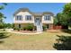 Charming yellow two-story home featuring a well-maintained front yard with mature landscaping at 3540 Owl Brow Ct, Cumming, GA 30028