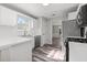 Bright kitchen featuring white cabinets, stainless steel appliances, and wood flooring at 3540 Owl Brow Ct, Cumming, GA 30028