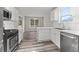 Well-lit kitchen with stainless steel appliances and sleek countertops at 3540 Owl Brow Ct, Cumming, GA 30028