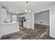Modern kitchen with white cabinets, new appliances, and an open view to the Gathering room at 3540 Owl Brow Ct, Cumming, GA 30028