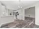 Open concept kitchen featuring stainless steel appliances and white cabinets at 3540 Owl Brow Ct, Cumming, GA 30028