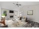 Bright, open living room with fireplace, vaulted ceilings, ceiling fan, recessed lighting, and neutral walls at 3540 Owl Brow Ct, Cumming, GA 30028