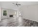 Bright, open living room with fireplace, vaulted ceilings, ceiling fan, recessed lighting, and neutral walls at 3540 Owl Brow Ct, Cumming, GA 30028