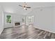Spacious living room with fireplace, vaulted ceilings, and a door leading to the outdoor deck at 3540 Owl Brow Ct, Cumming, GA 30028