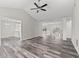 Bright living room with vaulted ceiling, ceiling fan, and modern flooring at 3540 Owl Brow Ct, Cumming, GA 30028
