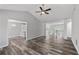 Open-concept living room with view to the kitchen, hardwood floors and bright airy space at 3540 Owl Brow Ct, Cumming, GA 30028