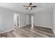 Large main bedroom with ceiling fan, wood-look floors, and doorways to en suite at 3540 Owl Brow Ct, Cumming, GA 30028