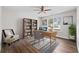 A staged office with a bookshelf, desk, and chair at 3540 Owl Brow Ct, Cumming, GA 30028