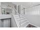 Bright interior featuring a modern staircase, neutral paint, and views into the living area at 3540 Owl Brow Ct, Cumming, GA 30028