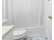 Bright bathroom featuring a bathtub with shower and toilet at 3987 Howell Park Rd, Duluth, GA 30096