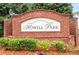 Charming brick community sign for Howell Park, with manicured landscaping and inviting entrance at 3987 Howell Park Rd, Duluth, GA 30096