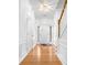 A bright entryway with hardwood floors, white trim, and a staircase leading to the upper level of the home at 3987 Howell Park Rd, Duluth, GA 30096