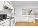 Bright kitchen with stainless steel appliances, white cabinets, and hardwood floors at 3987 Howell Park Rd, Duluth, GA 30096