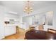 Open-concept kitchen featuring white cabinets, island, and modern lighting at 3987 Howell Park Rd, Duluth, GA 30096