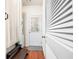 Functional mudroom/laundry area with hardwood floors, storage, and access to the exterior at 3987 Howell Park Rd, Duluth, GA 30096