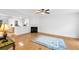 Bright living room featuring fireplace, light hardwood flooring, and natural light from adjoining room at 3987 Howell Park Rd, Duluth, GA 30096