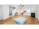 Bright living room features light hardwood flooring, neutral walls, and a cozy fireplace at 3987 Howell Park Rd, Duluth, GA 30096