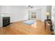 Bright living room with hardwood floors, fireplace, and natural light at 3987 Howell Park Rd, Duluth, GA 30096
