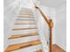 Staircase with wooden treads, white risers, and wood railing at 3987 Howell Park Rd, Duluth, GA 30096