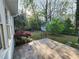 Relaxing backyard with patio, small shed, green grass, trees, and peaceful nature views at 2875 Oak Meadow Dr, Snellville, GA 30078