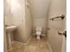 Cozy half bathroom featuring tile floors, sink, toilet, and towel rack at 2875 Oak Meadow Dr, Snellville, GA 30078