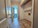 Bathroom and closet with tiled floors and vanity, featuring gray walls and a doorway at 2875 Oak Meadow Dr, Snellville, GA 30078