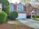 Charming two-story home with a brick and siding exterior, driveway, and a well-manicured lawn at 2875 Oak Meadow Dr, Snellville, GA 30078