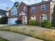 Inviting two-story brick home featuring a manicured lawn and an attached two-car garage at 2875 Oak Meadow Dr, Snellville, GA 30078