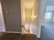 Hallway featuring carpeted stairs leading down and an open doorway leading to a carpeted room at 2875 Oak Meadow Dr, Snellville, GA 30078