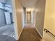 Long hallway with carpet, leading to bedrooms and other rooms at 2875 Oak Meadow Dr, Snellville, GA 30078