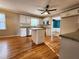 Well-lit kitchen with hardwood floors, an island, white cabinets, and stainless steel appliances at 2875 Oak Meadow Dr, Snellville, GA 30078
