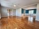 Open-concept room with hardwood floors, teal accent wall, crown molding, and lots of natural light at 2875 Oak Meadow Dr, Snellville, GA 30078