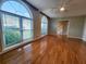 Bright living room featuring hardwood floors, arched windows, and a ceiling fan at 2875 Oak Meadow Dr, Snellville, GA 30078