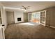 Spacious living room with fireplace, neutral carpet, french doors, and natural light at 2875 Oak Meadow Dr, Snellville, GA 30078