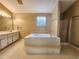 Main bathroom featuring a garden tub, separate shower, and double vanity at 2875 Oak Meadow Dr, Snellville, GA 30078