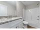 Bathroom featuring granite counters, undermount sink, and tub and shower combination at 2990 Fareed St, Douglasville, GA 30135