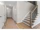Bright hallway with white trim, interior doors, and a staircase with decorative iron railings at 2990 Fareed St, Douglasville, GA 30135