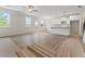 Open-concept living space with large windows, and a kitchen island with white cabinets at 2990 Fareed St, Douglasville, GA 30135