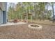 Backyard features a patio, outdoor kitchen, and stone fire pit at 135 Clear Spring Lane, Oxford, GA 30054