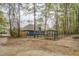 Back exterior view showcasing backyard, outdoor kitchen, patio, firepit, and fencing at 135 Clear Spring Lane, Oxford, GA 30054