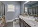 Bathroom with gray walls, vanity with white countertop, shower with curtain, and window at 135 Clear Spring Lane, Oxford, GA 30054