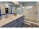 Modern bathroom with double sinks, a glass-enclosed shower, and stylish fixtures at 135 Clear Spring Lane, Oxford, GA 30054