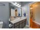 Bathroom features gray vanity with white countertop, large mirror, and hallway view at 135 Clear Spring Lane, Oxford, GA 30054