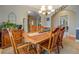 Cozy dining room with a wooden table set and a view of the entryway and staircase at 135 Clear Spring Lane, Oxford, GA 30054