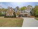 Charming stone and siding home with a well-manicured lawn and a long concrete driveway at 135 Clear Spring Lane, Oxford, GA 30054