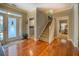 Inviting foyer with hardwood floors, a staircase, and views into the laundry and a bedroom at 135 Clear Spring Lane, Oxford, GA 30054