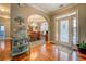 Inviting foyer with gleaming hardwood floors and an arched entryway to the formal dining room at 135 Clear Spring Lane, Oxford, GA 30054