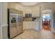 Bright kitchen with stainless steel appliances, white cabinets, and tile flooring at 135 Clear Spring Lane, Oxford, GA 30054