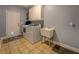 Functional laundry room with modern appliances, ample counter space, and a utility sink at 135 Clear Spring Lane, Oxford, GA 30054